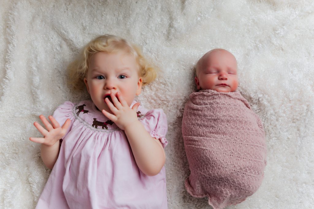 toddler and newborn sibling photo