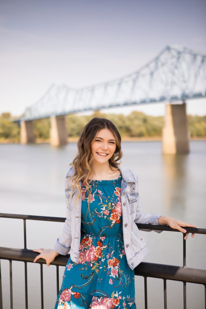 girl at smothers park in front of bridge