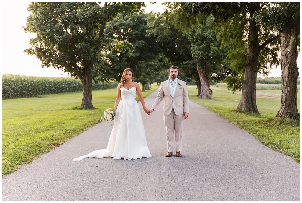 classic bride and groom photo on tree lined road