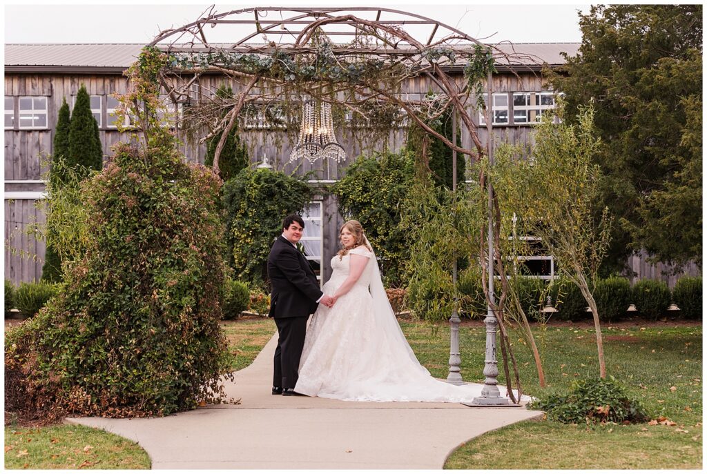 Brittany and William outside under chandelier