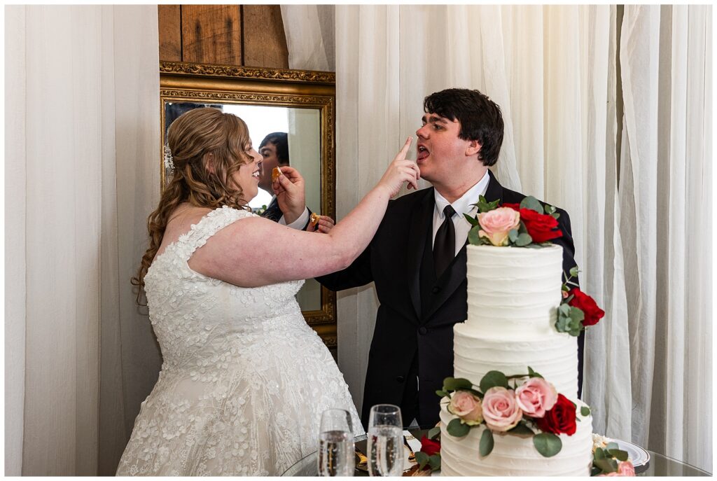 bride and groom feeding each other cake